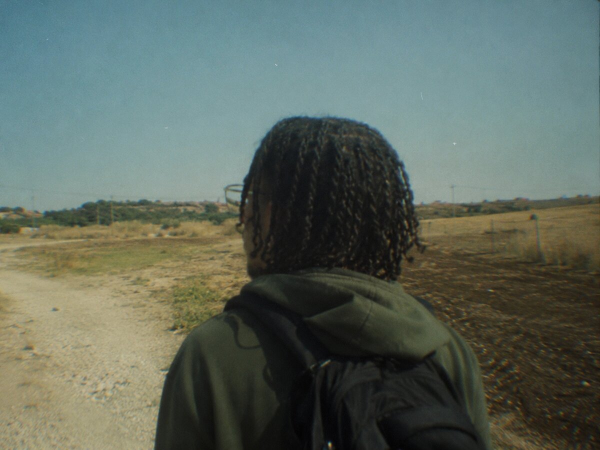 walking a dirt road, back turned